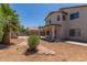 Exterior view of the house from the expansive backyard, featuring a covered patio at 6350 W Hess St, Phoenix, AZ 85043