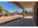 Large backyard with a covered patio, block fence, and desert landscaping at 6350 W Hess St, Phoenix, AZ 85043