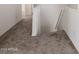 Hallway with neutral carpeting leading to a staircase with white banisters and a metal handrail at 6350 W Hess St, Phoenix, AZ 85043