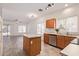 Bright kitchen with stainless steel appliances, wooden cabinets, island and sliding doors to backyard patio at 6350 W Hess St, Phoenix, AZ 85043