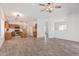 Open-concept living room featuring hardwood floors, a ceiling fan, and a view of the connected kitchen and dining area at 6350 W Hess St, Phoenix, AZ 85043