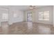 Bright, open living room with wood-look tile flooring and sliding glass doors at 6350 W Hess St, Phoenix, AZ 85043