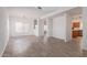 Bright, open living room with wood-look tile flooring and modern chandelier at 6350 W Hess St, Phoenix, AZ 85043