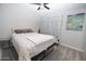 Bedroom featuring neutral carpet and walls, a ceiling fan and an abstract painting at 6454 E University Dr # 5, Mesa, AZ 85205