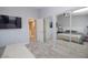 Bedroom featuring neutral carpet and walls, double windows and a sliding closet door at 6454 E University Dr # 5, Mesa, AZ 85205