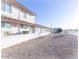 Exterior view of a building with light stucco, a brick roof, and address sign at 6454 E University Dr # 5, Mesa, AZ 85205