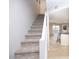 Carpeted staircase leading to the upper level of the home, flooded with natural light at 6454 E University Dr # 5, Mesa, AZ 85205