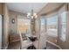 Bright dining area with a modern chandelier and lots of natural light through large windows at 650 N Hawes Rd # 3607, Mesa, AZ 85207