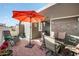 Cozy patio with a stylish seating area under an umbrella and a modern outdoor heater for comfortable outdoor living at 650 N Hawes Rd # 3607, Mesa, AZ 85207