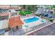 A high angle shot of the community pool and hot tubs, featuring lounge seating and nearby restrooms at 650 N Hawes Rd # 3607, Mesa, AZ 85207