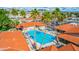 Aerial capture of the pool area featuring modern lounge furniture, lush palm trees, and a nearby hot tub at 650 N Hawes Rd # 3607, Mesa, AZ 85207