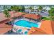 Aerial view of a pool with lounge chairs, a covered patio, and palm trees around the pool area at 650 N Hawes Rd # 3607, Mesa, AZ 85207