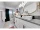 Bathroom featuring dual sinks, white cabinets, gray counters and walk-in shower at 6634 N 16Th Dr, Phoenix, AZ 85015