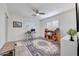 Bedroom with ceiling fan, wood floors, shuttered windows, desk and shelving at 6634 N 16Th Dr, Phoenix, AZ 85015