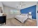 Cozy bedroom with ceiling fan, white and blue walls, and plantation shutters at 6634 N 16Th Dr, Phoenix, AZ 85015