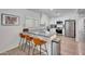 Modern kitchen featuring a breakfast bar with leather stools and stainless steel appliances at 6634 N 16Th Dr, Phoenix, AZ 85015