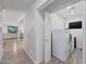 Bright laundry room featuring a washer and dryer with white cabinets and walls at 6634 N 16Th Dr, Phoenix, AZ 85015