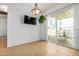 Dining area featuring tiled floors, sliding glass doors, and a modern light fixture at 6720 W Medlock Dr, Glendale, AZ 85303