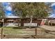 Charming single-story home featuring a well-manicured front yard and a rustic wooden fence at 6720 W Medlock Dr, Glendale, AZ 85303