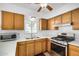 A kitchen showcasing stainless steel appliances, wood cabinets, and tiled floors at 6720 W Medlock Dr, Glendale, AZ 85303