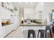 Bright kitchen featuring white cabinetry, neutral countertops, and barstool seating at 698 W Merrill Ave, Gilbert, AZ 85233