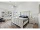 Bright primary bedroom featuring a white wood bed frame, neutral walls, and large shuttered windows at 698 W Merrill Ave, Gilbert, AZ 85233