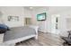 Bright primary bedroom featuring a white wood bed frame, neutral walls, and view of attached bathroom at 698 W Merrill Ave, Gilbert, AZ 85233