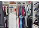 Organized walk-in closet with shelving, hanging rods, and a variety of clothing items neatly stored at 698 W Merrill Ave, Gilbert, AZ 85233