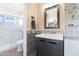 This bathroom has a nice sink and vanity, a large mirror, tile backsplash and shower in the background at 713 N Banning Cir, Mesa, AZ 85205