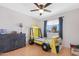 bedroom with hardwood floors, ceiling fan, large window and a yellow race car style bed at 713 N Banning Cir, Mesa, AZ 85205