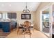 A dining room with a wood table set with four chairs and sliding glass doors at 713 N Banning Cir, Mesa, AZ 85205