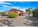 Two-story home with a long driveway and an attached garage against a bright blue sky at 713 N Banning Cir, Mesa, AZ 85205