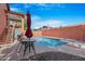 Inviting pool area with an umbrella, lounge chairs, and clear blue water for relaxation at 713 N Banning Cir, Mesa, AZ 85205