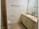 Bright bathroom with a toilet, sink, travertine flooring, and a mirror at 7147 E Rancho Vista Dr # 3010, Scottsdale, AZ 85251