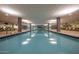 Indoor lap pool with abundant natural light, lounge chairs, and access to a gym at 7147 E Rancho Vista Dr # 3010, Scottsdale, AZ 85251