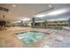 Indoor pool area featuring a hot tub, lounge chairs, and access to gym at 7147 E Rancho Vista Dr # 3010, Scottsdale, AZ 85251