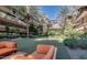 Outdoor putting green among lush trees, a lounge chair, and building at 7147 E Rancho Vista Dr # 3010, Scottsdale, AZ 85251