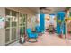 Inviting covered patio featuring blue accent chairs, ceiling fan, and an open view to the yard at 7322 S Sunset Way, Buckeye, AZ 85326