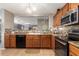 Well-lit kitchen featuring wood cabinetry, stainless steel appliances, and a stylish backsplash at 7322 S Sunset Way, Buckeye, AZ 85326