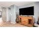 Comfortable living room area with a large flat-screen TV and a decorative credenza at 7322 S Sunset Way, Buckeye, AZ 85326