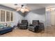 Cozy living room area with comfortable seating, tile floors, neutral paint, and shutters at 7322 S Sunset Way, Buckeye, AZ 85326