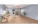 Inviting living room with light blue walls, wood floors, fireplace, and decorative plants at 7322 S Sunset Way, Buckeye, AZ 85326