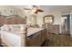 Comfortable bedroom featuring a decorative ceiling fan, stylish dresser, and wood-look flooring at 7322 S Sunset Way, Buckeye, AZ 85326