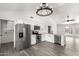 Kitchen with stainless steel appliances, white cabinets, island, and wood-look floors at 7326 W Georgia Ave, Glendale, AZ 85303