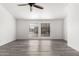 Bright, spacious living room featuring a ceiling fan and stylish, modern gray flooring at 7326 W Georgia Ave, Glendale, AZ 85303