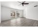 Bright, spacious living room featuring a ceiling fan and stylish, modern gray flooring at 7326 W Georgia Ave, Glendale, AZ 85303