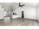 Bright, open-concept living space featuring a modern kitchen and stylish gray flooring at 7326 W Georgia Ave, Glendale, AZ 85303