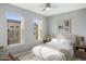 Cozy bedroom with ceiling fan, two sunny windows, neutral walls and light colored carpet at 7472 E Paraiso Dr, Scottsdale, AZ 85255