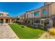 A community amenity space with turf, seating, covered area and cornhole game at 7472 E Paraiso Dr, Scottsdale, AZ 85255