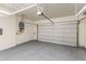 View of the open garage space featuring epoxy floors, garage door and water heater at 7472 E Paraiso Dr, Scottsdale, AZ 85255